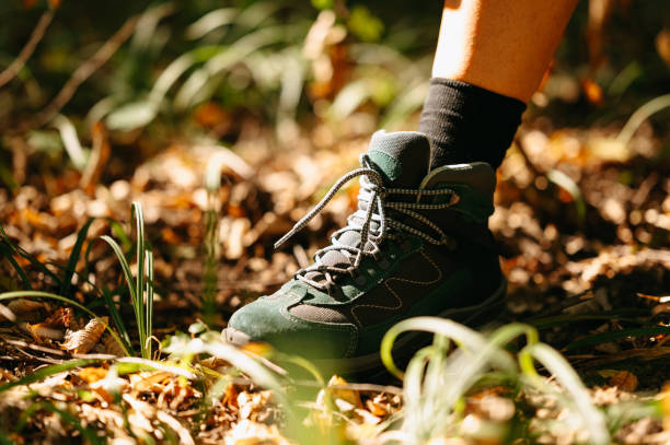 istock A closeup image captures a hiking boot making its way across a forest floor abundantly adorned with autumn leaves 2170351664