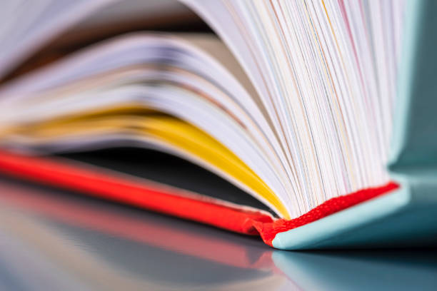 istock Opened hard cover book pages with toned color background 2170354182