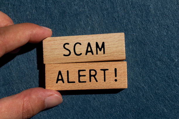 istock Scam alert message written on wooden blocks with gray background 2170355267