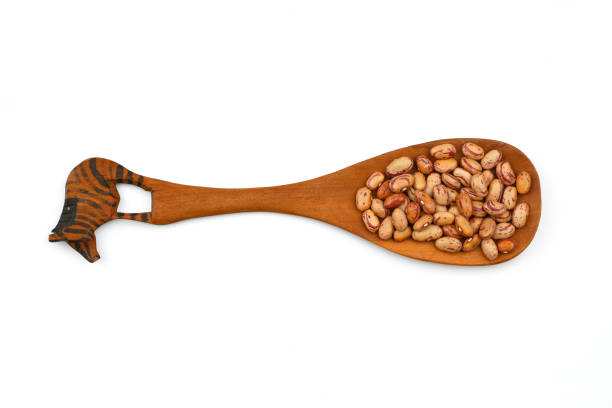 red kidney beans in wooden spoon isolated on white background.