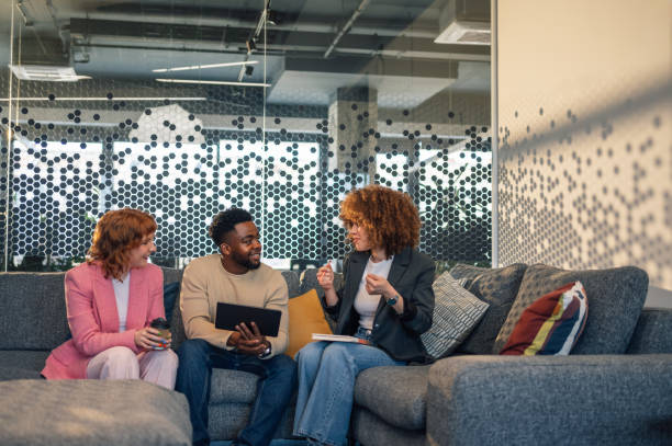 istock Interracial professionals at office lobby with tablet on a briefing. 2170356943