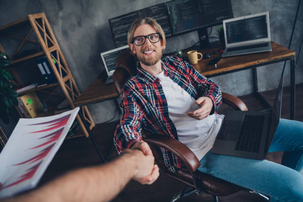 istock Photo of successful young positive it specialist senior level programmer gets contract offer shaking hands with ceo company at office 2170357712