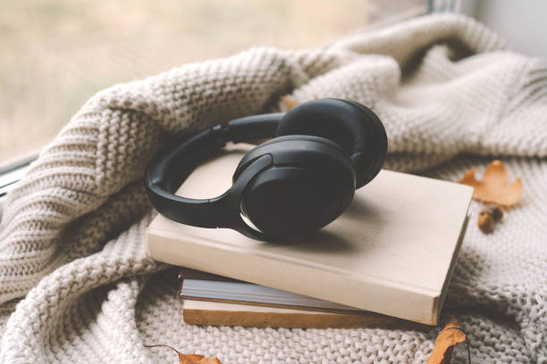 istock Cozy autumn setting with headphones on a book 2170359618