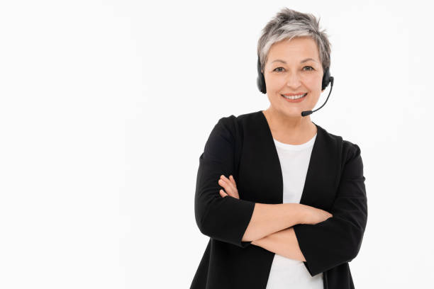 Mature woman call center worker customer support wired headset smiling isolated on white background