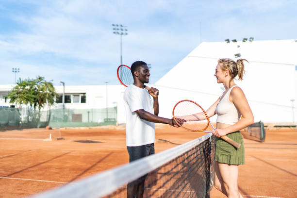 istock Two young friends shaking hands after tennis match 2170359755