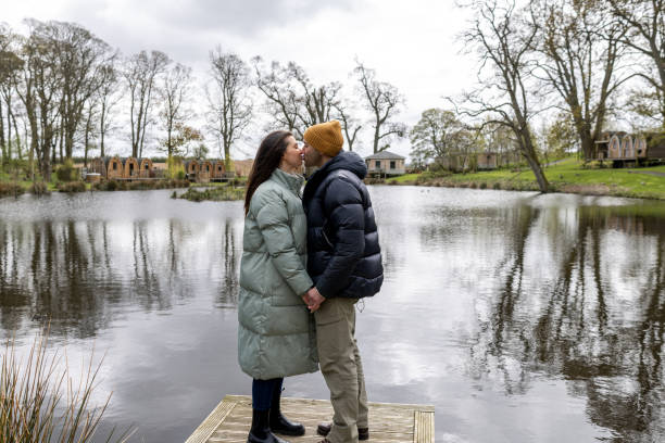 Couple Sharing a Kiss at the Lakeside