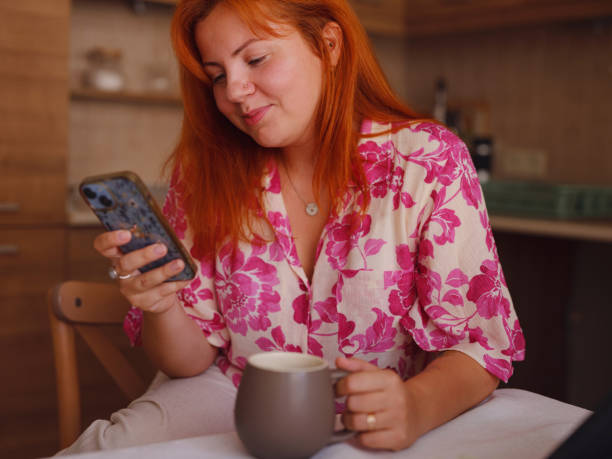 istock young woman working on tablet at kitchen 2170365811