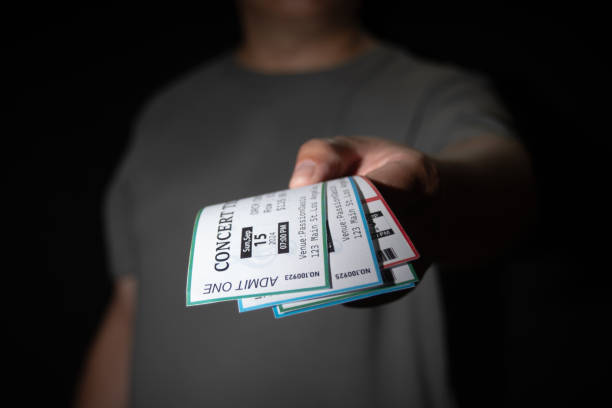 istock A hand extracts three concert tickets from a pocket, a common tactic used in ticket scalping 2170367129