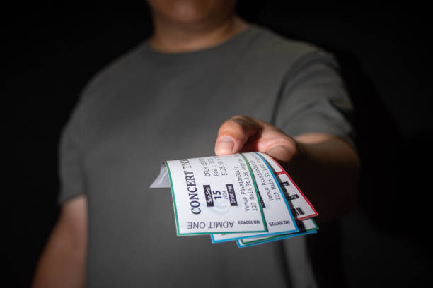istock A hand extracts three concert tickets from a pocket, a common tactic used in ticket scalping 2170367132