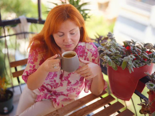 istock Woman drinking tea at the balcony 2170367386