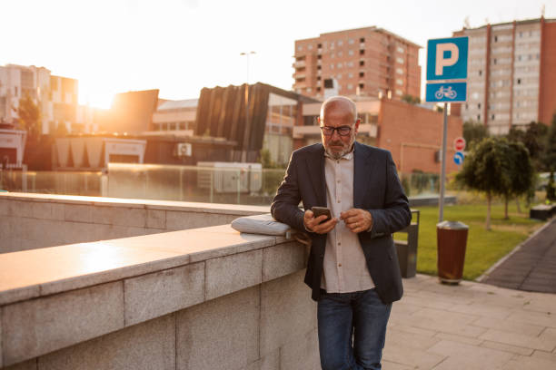 istock Businessman text messaging in front of the office building 2170367503