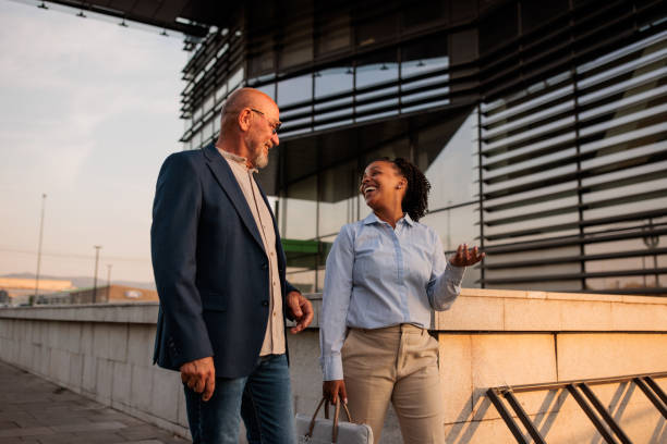 Two people walking outdoors in a business area
