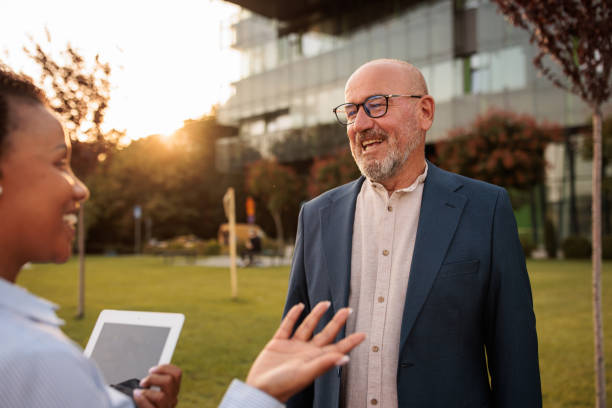 istock Two people talking business outdoors in a business area 2170368280