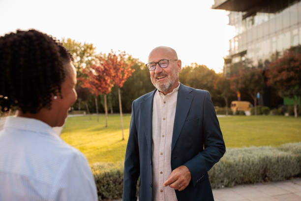 istock Two people having a business conversation outdoors in a business area 2170368781