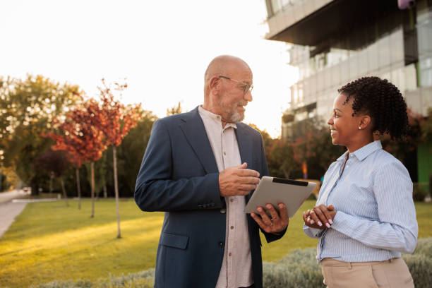 istock Two people talking outdoors in a business area 2170369244