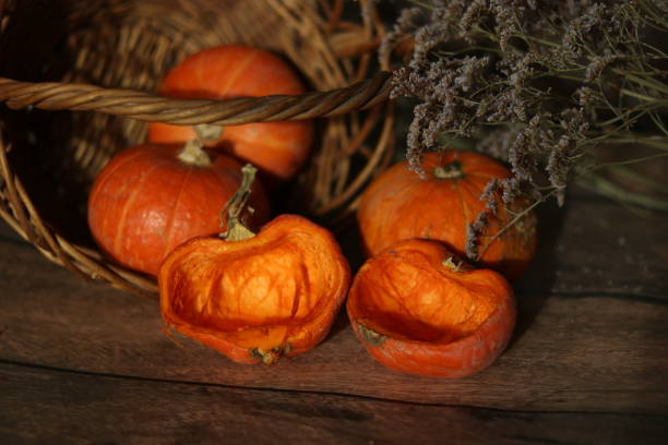 istock orange pumpkins lie on the table, next to the basket 2170369582