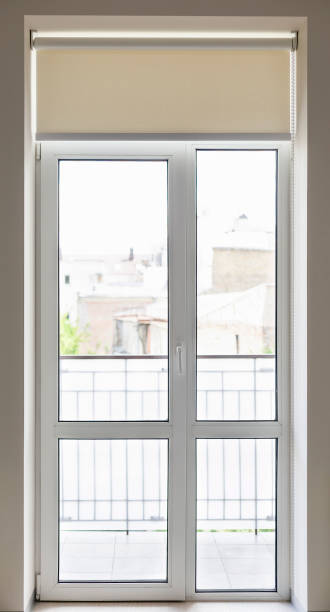 istock Modern balcony door with roller blind overlooking a cityscape on a bright day 2170374353