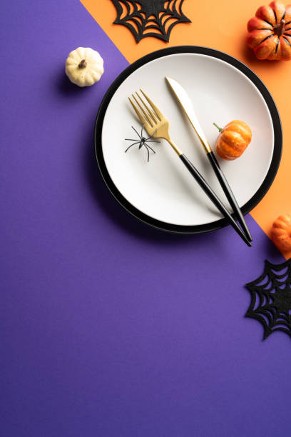 istock Festive vertical Halloween table setting with pumpkins, black spiders, and gothic decorations. Perfect for holiday celebrations and themed parties 2170374950