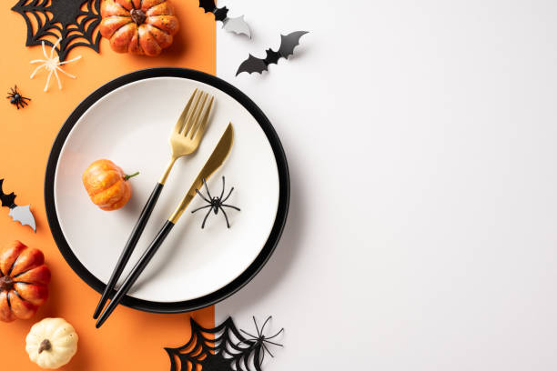istock Halloween dinner table setup featuring pumpkins, spiders, bats, and festive cutlery creating a spooky atmosphere 2170374958