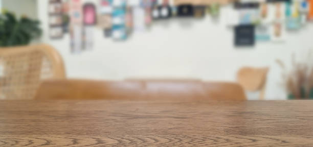 istock walnut wooden counter table at foreground with blurry bokeh cafe indoor at background. real countertop image for displayed products. 2170377409