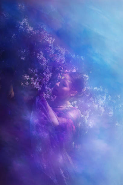 Young woman enjoyes the closeness to a beauty bush at springtime.