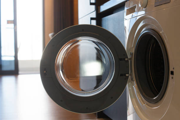 istock Close-up of opened washing machine in room. 2170378800