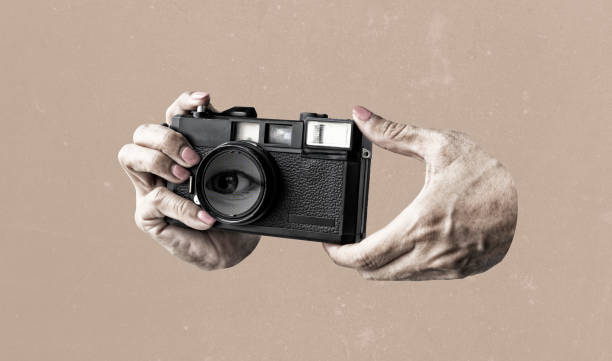 istock Retro camera, eye in a human hand vintage background. Art collage digital pop modern art 2170379595