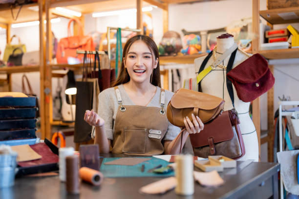 istock Leather studio craftman asian artisan working with leather bags part while gluing piece bag handle,The process of gluing leather tanned leather craft materials by a craftsman 2170379815