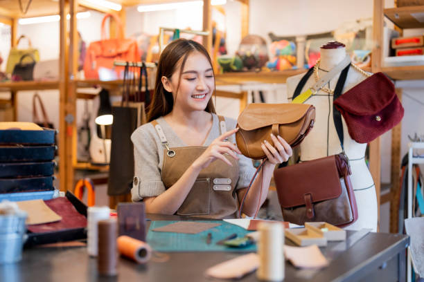 istock Leather studio craftman asian artisan working with leather bags part while gluing piece bag handle,The process of gluing leather tanned leather craft materials by a craftsman 2170379827