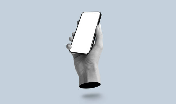 istock Black blank screen of mobile phone. Hand holding phone with empty screen in hand on grey background. Art collage digital pop modern art 2170379913