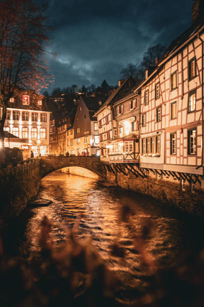 German Eifel village of Monschau during christmas time with lots of snow. Panoramic view into the Rur valley at night, Germany.