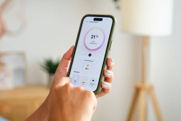 istock Woman controlling home appliances with smart home application on mobile phone 2170383626