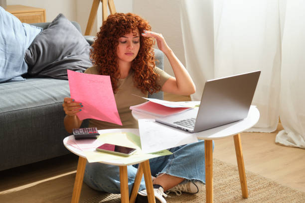 istock Freelancer woman feeling stressed, having financial problems doing taxes looking at invoices 2170384140