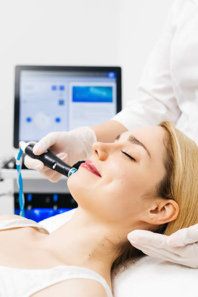 istock A professional cosmetologist performs hydropeeling and Hydradermabrasian on the client, providing advanced skin care procedures. Ideal for promoting luxury beauty services and enhancing your brand image. 2170384404