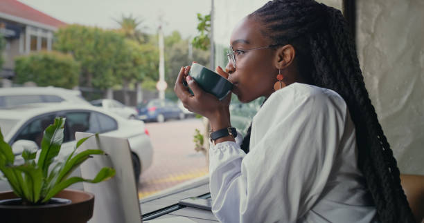 Coffee shop, thinking and black woman with remote work for copywriting, website report or social media post. Entrepreneur, internet cafe and tea drink for blog, inspiration and creative writing