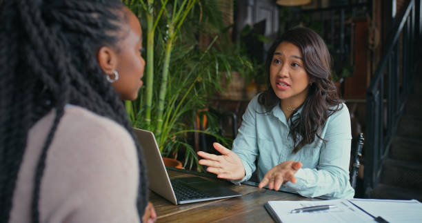 istock Women, client and financial advisor with contract for consulting, discussion and talking for investment. People, meeting and accountant speaking of taxes paperwork, legal advice and loan feedback 2170384507
