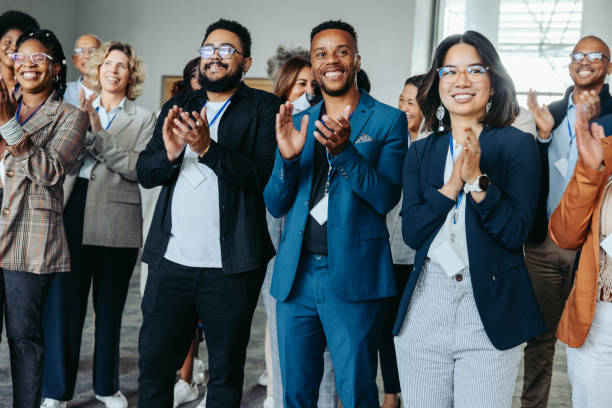 istock Diverse colleagues clapping at conference, happy employees celebrating success, unity in business 2170384802