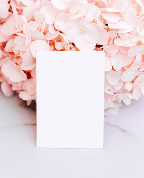 Mockup invitation or blank greeting card on a pink flower background