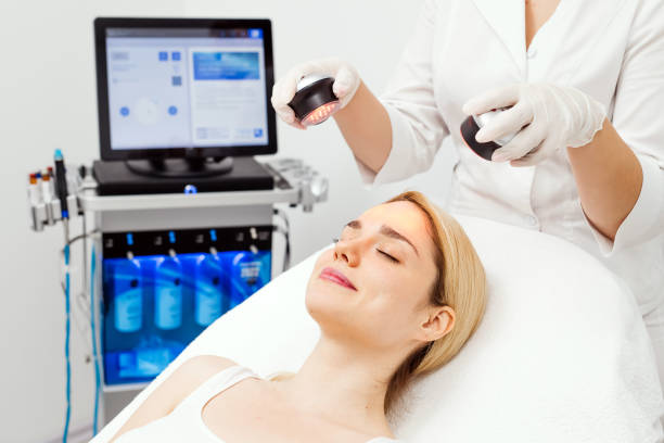 istock A cosmetologist performs LED light therapy for facial rejuvenation. This non-invasive treatment improves skin elasticity, reduces aging signs, and enhances overall skin radiance. 2170385160