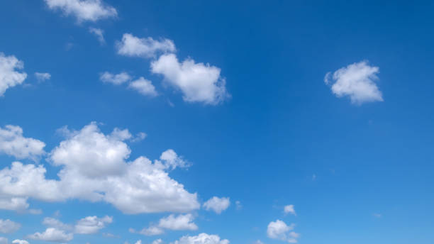 istock Panoramic view of clear blue sky and clouds, Blue sky background with tiny clouds. White fluffy clouds in the blue sky. Captivating stock photo featuring the mesmerizing beauty of the sky and clouds. 2170386010