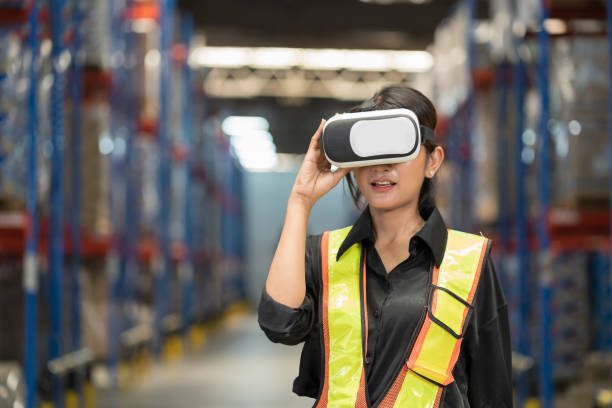 istock Female worker using virtual reality headset inspecting of product on shelf in storage warehouse. Warehouse worker wearing virtual reality headset at warehouse 2170386674