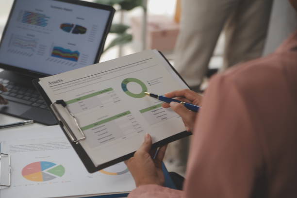 istock Close up of Business team analyzing income charts and graphs with modern laptop computer. Business analysis and strategy concept. 2170386717