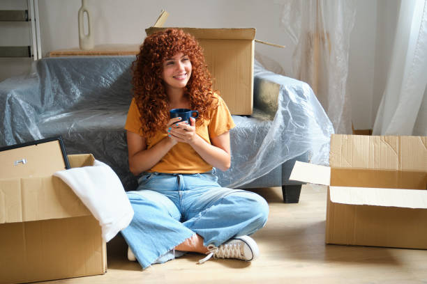 istock Woman taking break with coffee surrounded by moving boxes 2170387442