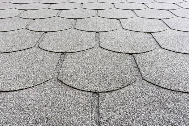 istock Mosaic style roof covered with bituminous shingles. Textured and durable roofing material provides weather protection. 2170390663