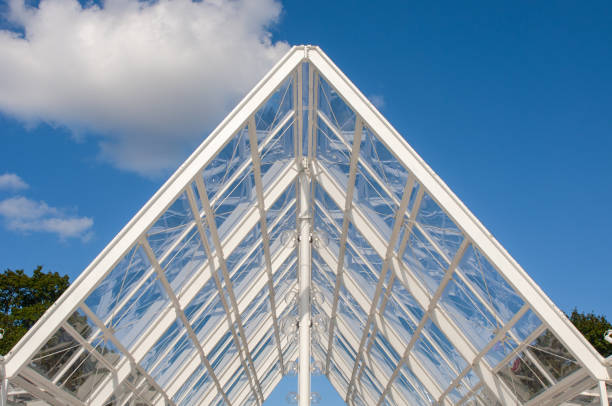 Modern structure of a glass ceiling on blue sky background