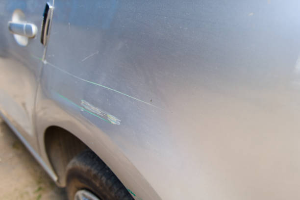 istock Minor scratch on the side of a silver vehicle parked in a rustic outdoor setting during daylight hours 2170397274