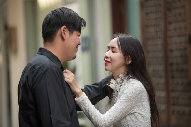 Asian young couple looking each other, male and female spending time together