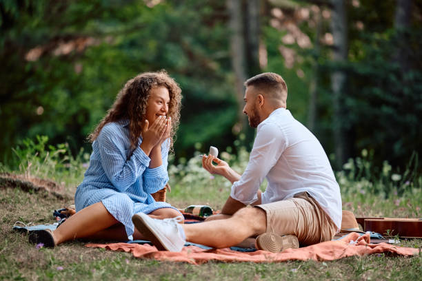 istock Happy man proposing his girlfriend on a picnic in nature. 2170397646