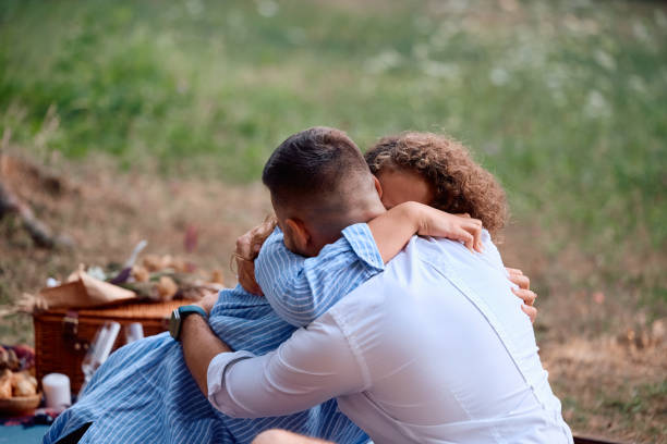 istock Affectionate couple embracing while having a picnic in the park. 2170397665