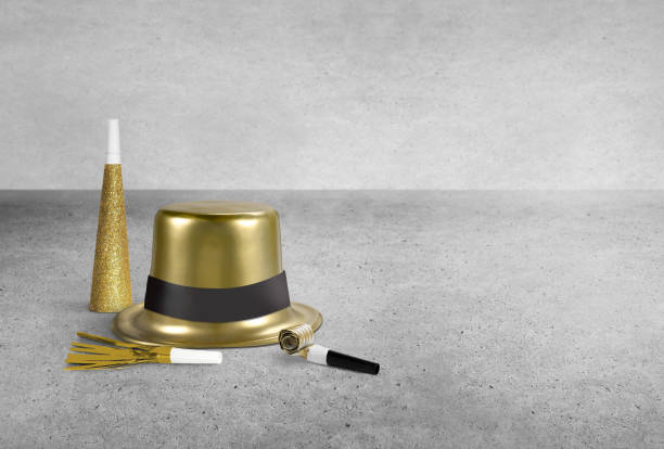 New Year's party hat and whistles on a concrete background
